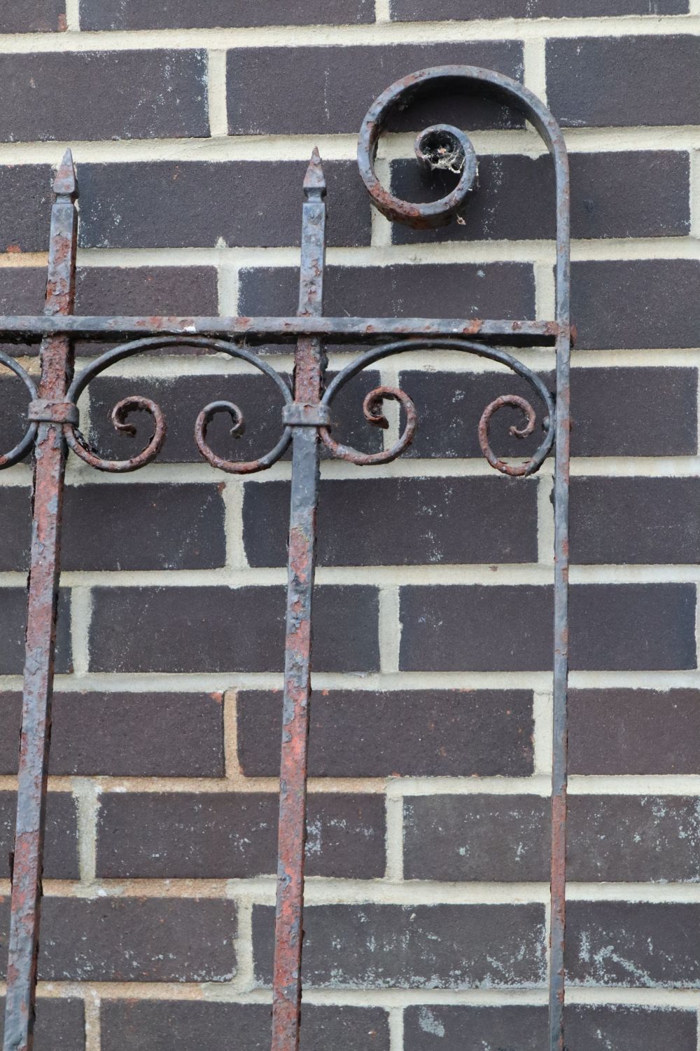 A pair of wrought iron gates, each gate 177cm wide, 193cm high